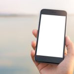 A hand holding a smartphone.